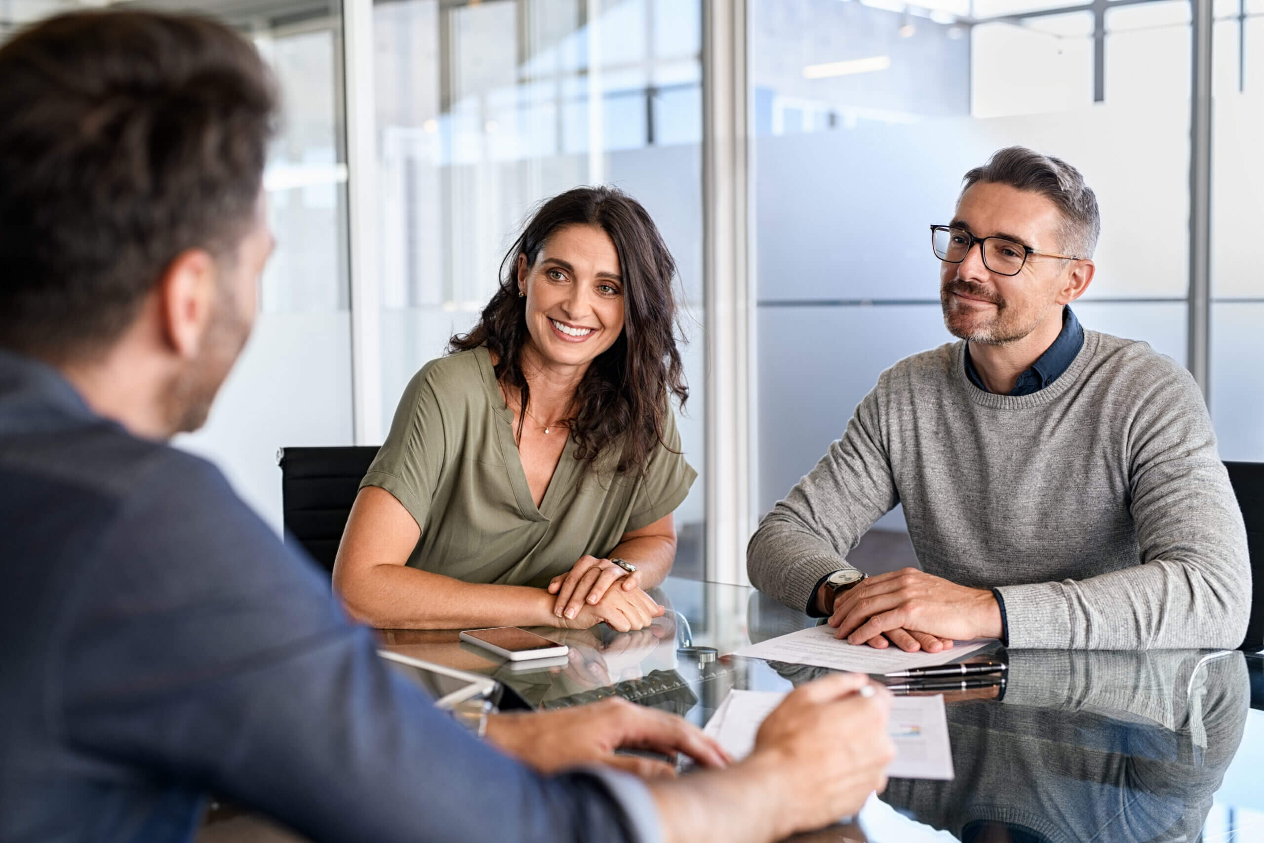 Professional advisor explaining benefits of participating whole life insurance to a couple, representing the service offered by Cardinal Life.