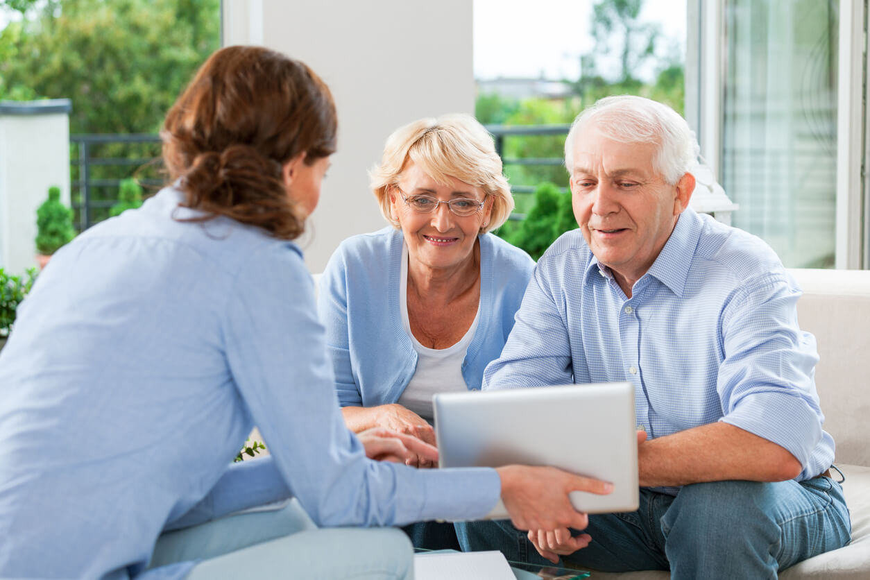 Senior couple discussing annuity benefits with a financial advisor, symbolizing secure retirement planning with Cardinal Life