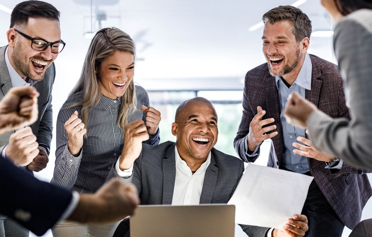 Business team celebrating successful company group benefits plan - Cardinal Life.