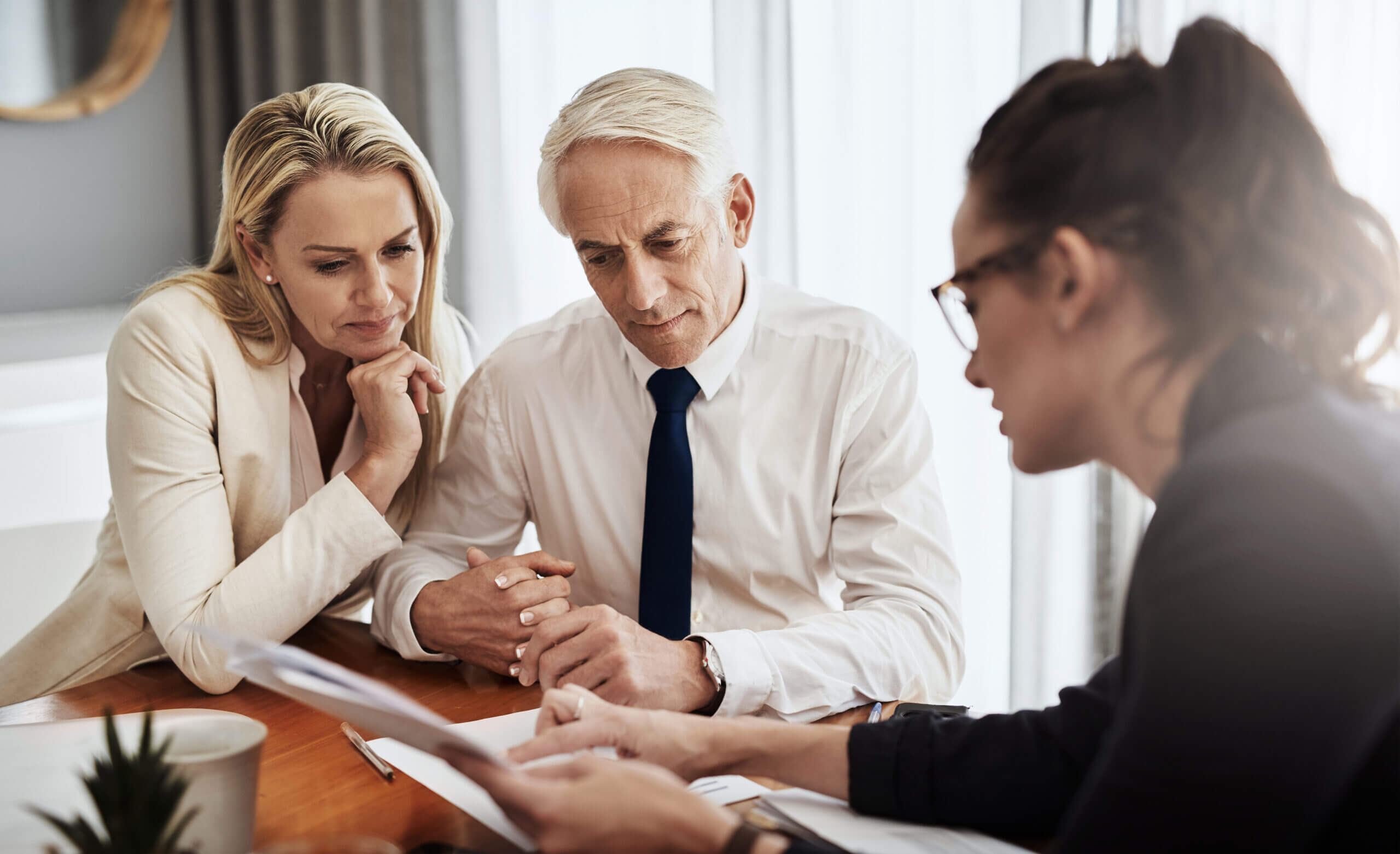 Professional advisor discussing universal life insurance with a couple, representing who should consider universal life insurance - Cardinal Life